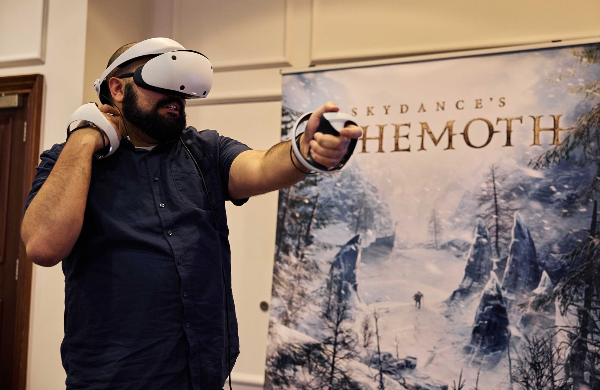 Bearded man wearing a PlayStation VR2 headset playing Behemoth