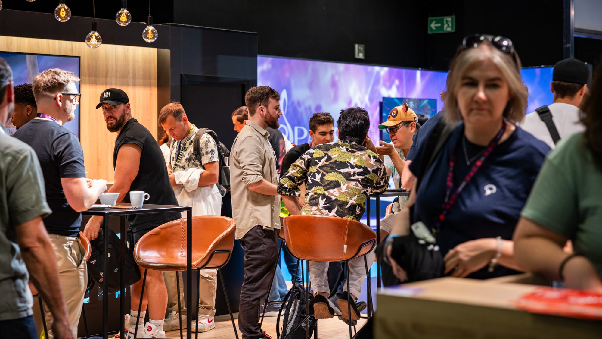 A dozen people sitting down around the "Home of XR" booth