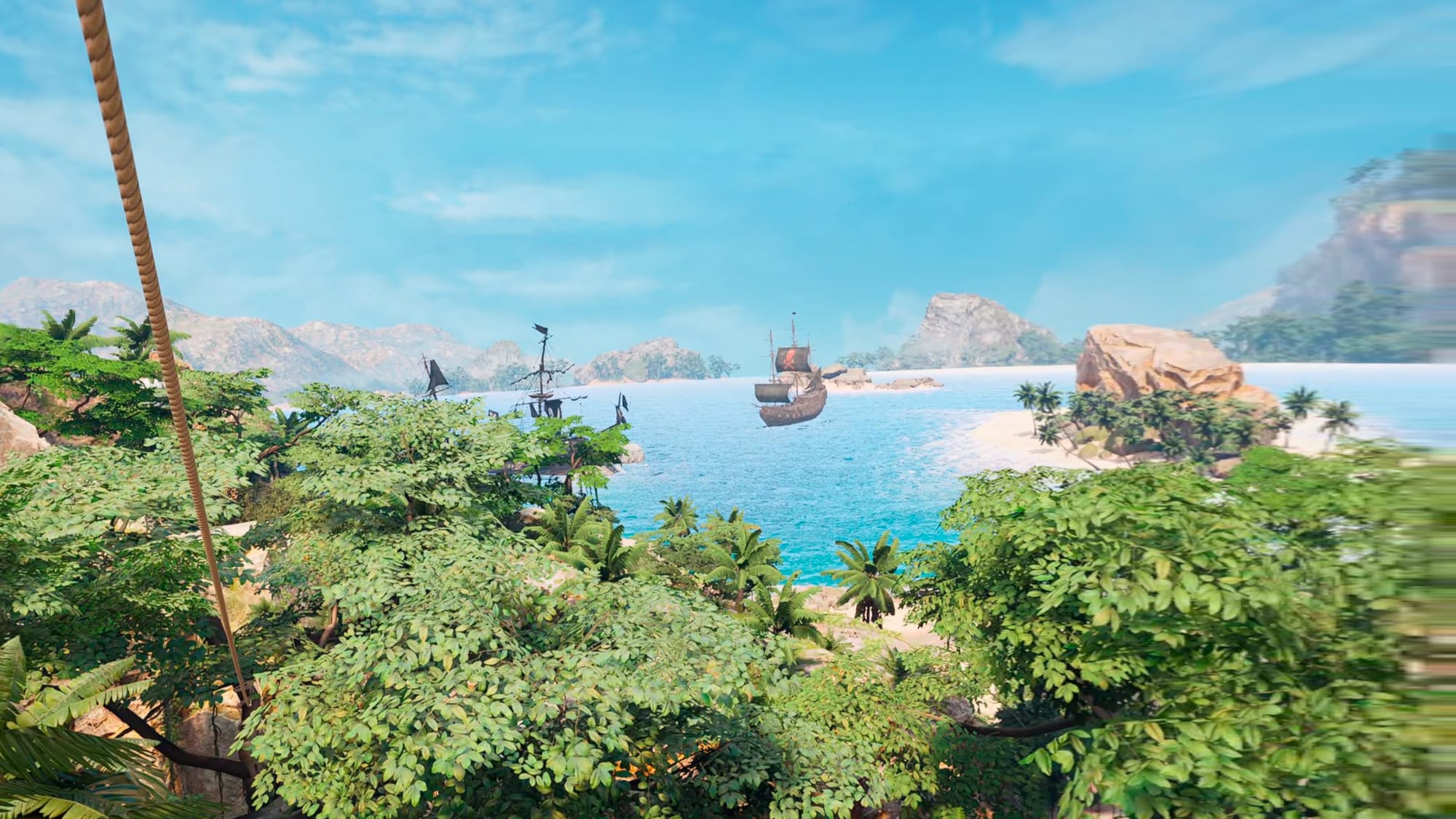 A pirate ship can be seen in a bay above a tree line