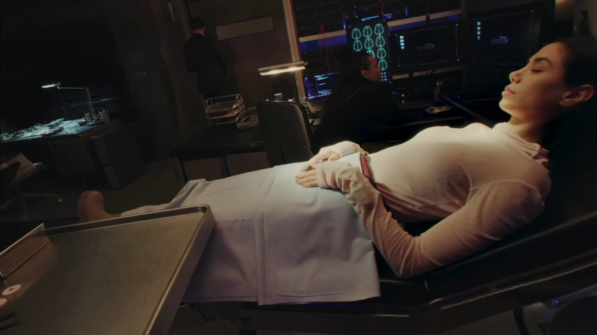 Human Within screenshot shows a woman laying down on a raised medical bed