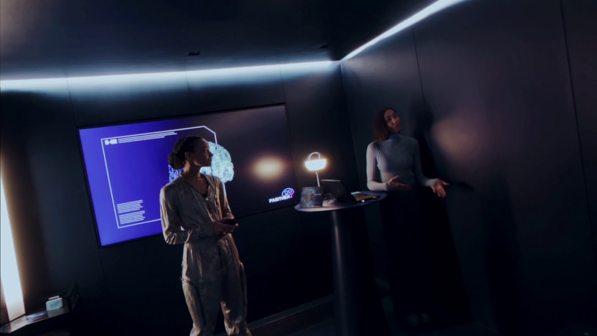 Human Within screenshot shows two characters talking by a standing table