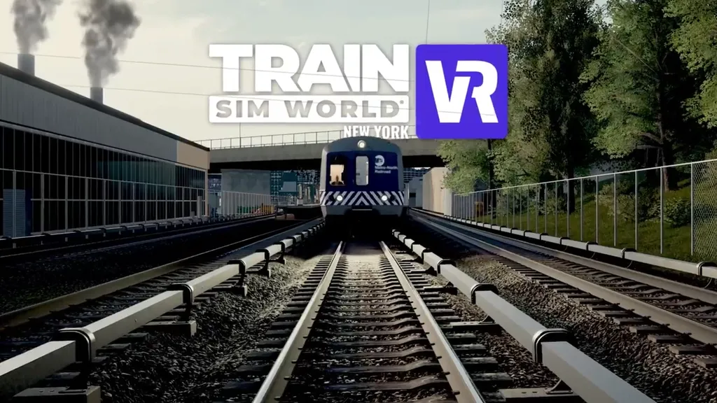 A modern train rolls down the track in part of New York city, with trees and a factory in view on either side